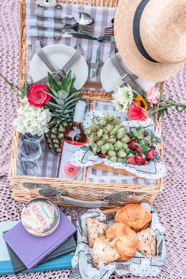 picnic basket with fruit, wine, and bread